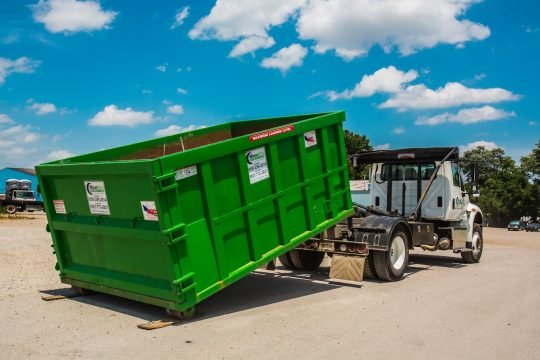 Green dumpster used for junk removal and construction debris in Boston area