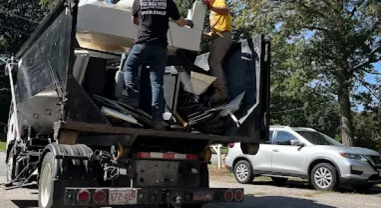 dumpster-rental Team Tough Guys delivering and setting up a dumpster for waste disposal