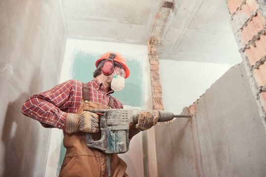 Professional demolition team safely tearing down a building structure