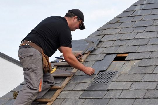 Professional team performing residential roof repair and installation